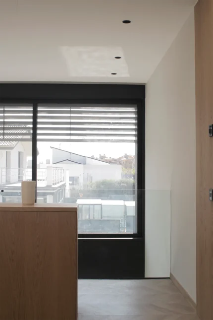 Pasillo de la planta primera de Casa Mérida con ventanal y entrada de luz natural.